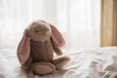 Beautiful plush rabbit on childrens bed. Childrens room. Cosy. Easter.