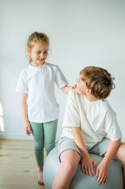 Küçük tatlı kız ve oğlan evde spor yapıyor..