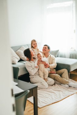 Evlerinde dinlenen küçük çocukları olan güzel, mutlu bir aile. Samimi.