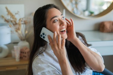 Genç bayan akıllı telefondan telefon görüşmesi yapıyor..