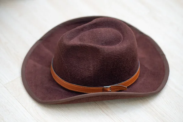 Brown Cowboy Hat on White Wooden Floor Close Up