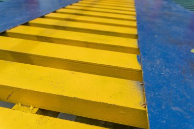 Colorful suspension bridge in the middle of a city park close up