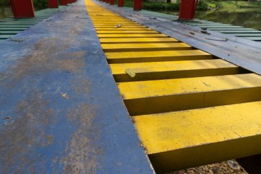 Colorful suspension bridge in the middle of a city park close up