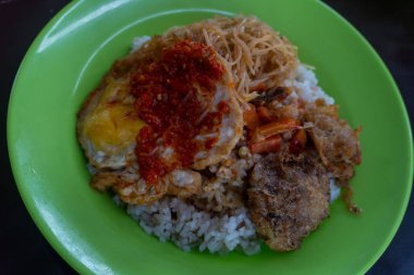 Morning breakfast consisting of rice, noodles, cakes and chili eggs on the street stall market