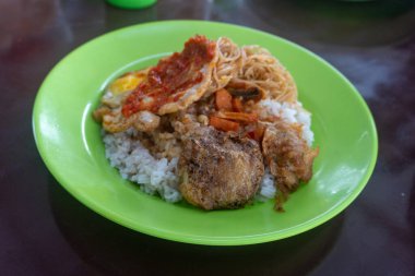 Morning breakfast consisting of rice, noodles, cakes and chili eggs on the street stall market