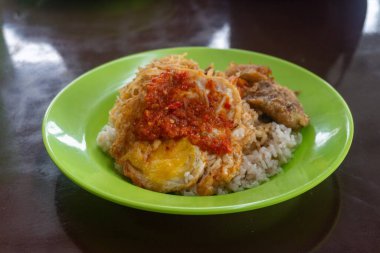 Morning breakfast consisting of rice, noodles, cakes and chili eggs on the street stall market