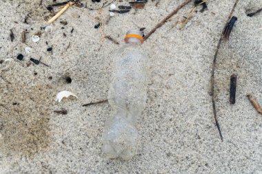 Plastic bottle waste on the white sand beach in nature landscape