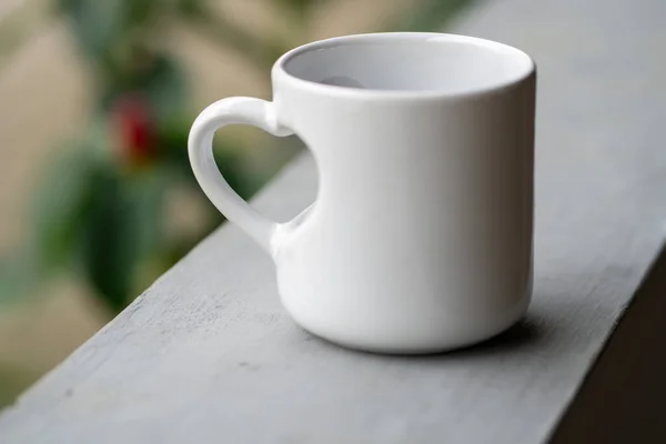 Love in Every Sip: A Close-Up of a White Mug with Love Handle