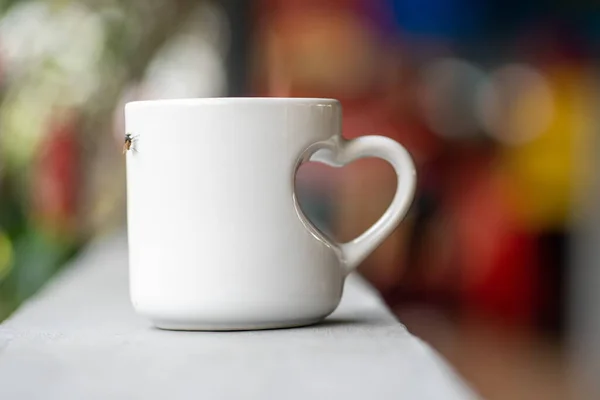 Love in Every Sip: A Close-Up of a White Mug with Love Handle