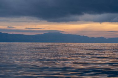 view of the horizon of lake toba in the morning with cloudy weather