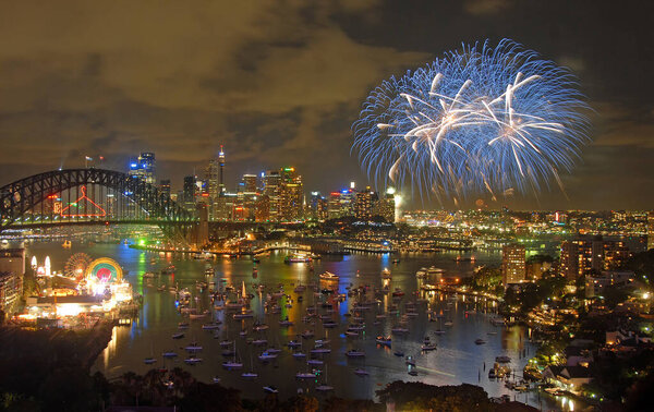 Sydney, New South Wales, Australia: Fireworks over Sydney Harbour to celebrate the New Year. Firework display with bridge, city and harbor.