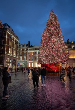 Londra, İngiltere - 8 Kasım 2023: Covent Garden Market 'in dışındaki büyük süslü Noel ağacı. Portre yönelimi.