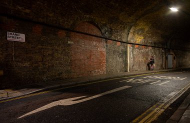 Bermondsey, London, UK: Shand Street passing through a road tunnel under the London Bridge to Greenwich Railway Viaduct in the London borough of Southwark. clipart