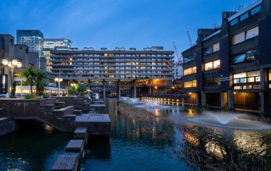 Londra, İngiltere: Londra 'daki Barbican Estate' te yapay göl ve çeşmeler. Barbican Malikanesi, Londra 'daki Brutalist mimarinin önemli bir örneğidir..