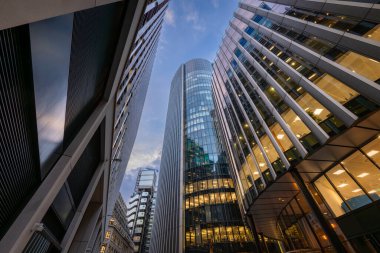 London, UK: Tall buildings in the City of London seen from Fenchurch Avenue with 120 Fenchurch Street (L), Willis Building (R), 25 Fenchurch Ave (far R) and Lloyds Building (distance). clipart