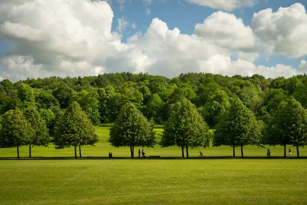 stock image Reigate, Surrey, UK: Priory Park in Reigate with people. This public park is close to Reigate town centre and features woodland, grass areas, a lake and visitor facilities.