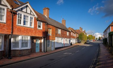 Burwash, East Sussex, UK: Burwash High Street with traditional old buildings. clipart