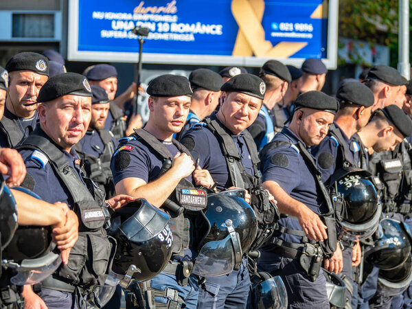 Bucharest, Romania - October 2022: : Police officers and Gendarmerie or military police closely supervising the demonstrators at a protest in Bucharest.