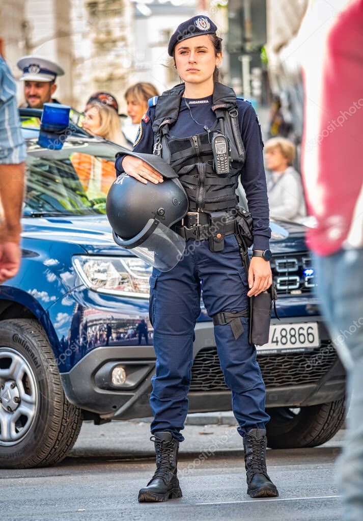 Bucharest, Romania - October 2022: Female police officers and Gendarmerie or military police closely supervising the demonstrators at a protest in Bucharest.