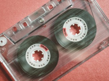 Old vintage cassette tapes on red background.