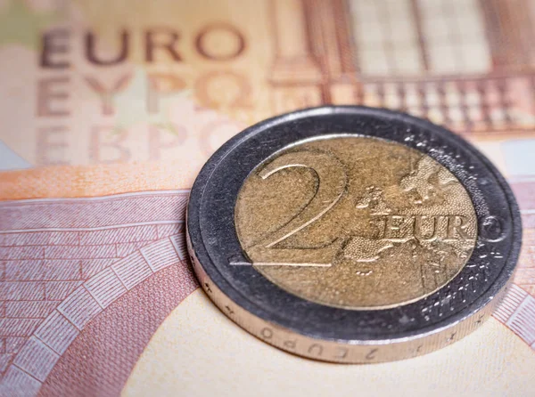 Macro picture of a 2 euro coin on a 50 Euro Banknote. European Currency Concept.