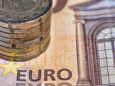 Macro picture with euro cent coins on a 50 Euro Banknote. European Currency Concept.