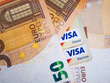 Macro picture of a 50 Euro Banknote and a Visa debit or credit card. European Currency Concept.