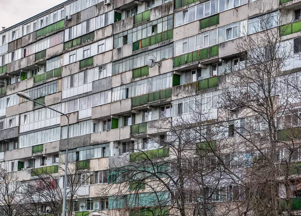 stock image Worn out apartment building from the communist era against blue sky in Bucharest Romania. Ugly traditional communist housing ensemble