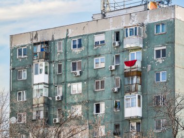 Bükreş 'teki mavi gökyüzüne karşı komünist dönemden kalma bir apartman binası. Çirkin geleneksel komünist konut topluluğu