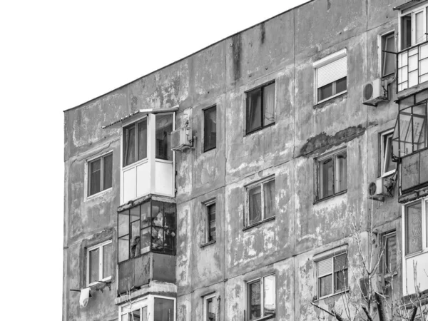Worn out apartment building from the communist era against blue sky in Bucharest Romania. Ugly traditional communist housing ensemble. Black and white abstract photography.