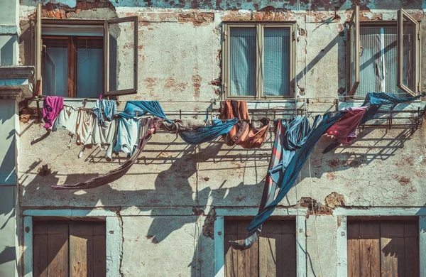 stock image Clothes laundry left to dry at the window of a old medieval building in Venice, Italy