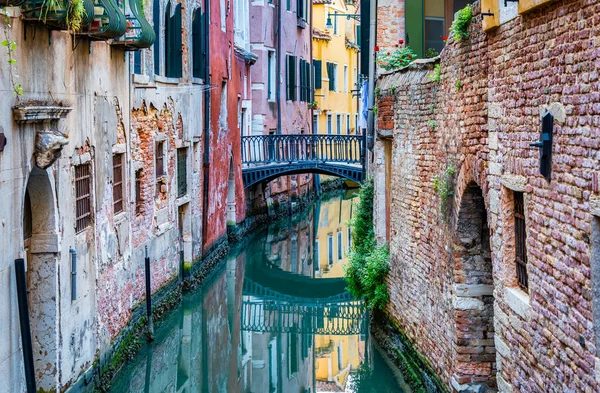 狭い水路と赤レンガは イタリアのヴェネツィアで水に建てられた建物を身に着けていました — ストック写真