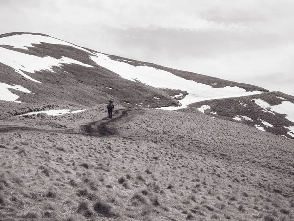 Lonely man on the mountain. Black and white photography.