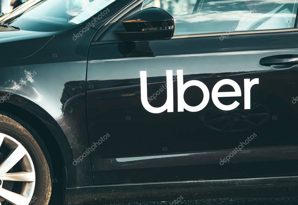 Bucharest, Romania -July 01 2023 : Car with the logo of the ride hailing company Uber in traffic.