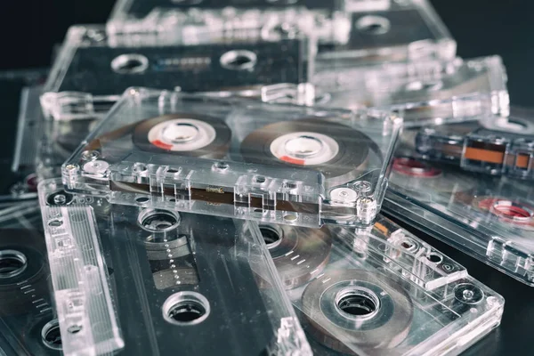 A stack of audio tape cassettes on black background. Retro vintage music concept.