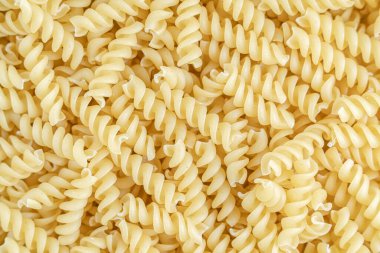 Bir yığın çiğ İtalyan fusilli spiral makarna. Doku arkaplanı.