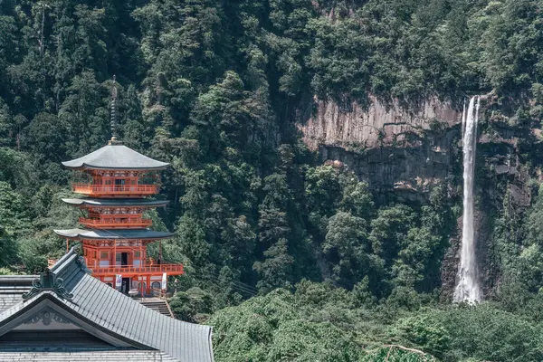stock image The red three-story pagoda of Seigantoji Buddhist Temple in front of Nachi Falls. Beautiful natural scenery in Nachikatsuura, Japan
