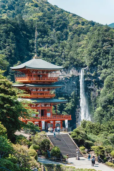 stock image The red three-story pagoda of Seigantoji Buddhist Temple in front of Nachi Falls. Beautiful natural scenery in Nachikatsuura, Japan