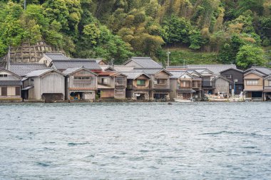 Beautiful scenic view with the wooden traditional waterfront boat houses called funaya around Ine Bay, in the village Ine, Japan clipart