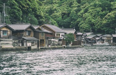 Beautiful scenic view with the wooden traditional waterfront boat houses called funaya around Ine Bay, in the village Ine, Japan clipart