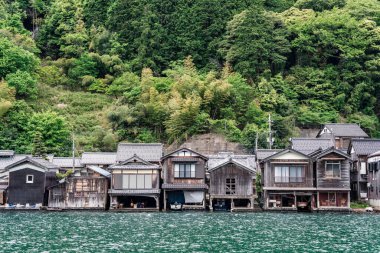 Beautiful scenic view with the wooden traditional waterfront boat houses called funaya around Ine Bay, in the village Ine, Japan clipart