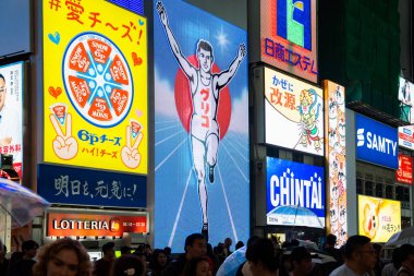 Osaka, Japan - 05.12.2024: The Glico Running Man neon sign in Dotombori district, one of the most popular landmarks in the city. clipart