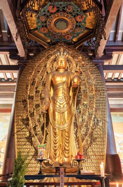 Osaka, Japan - 05.05.2024: The Amida Nyorai Buddha golden statue inside the Shitennoji Kondo (Golden Hall) clipart