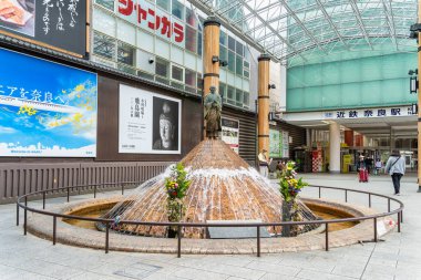 Nara, Japan - 05.06.2024: Gyoki small bronze figure statue on top of a small fountain just outside the Kintetsu Nara Station clipart