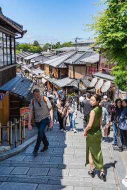 Kyoto, Japan - 05.09.2024: Tourist crowds walking on Ninenzaka and Sannenzaka pedestrian street in the center of Kyoto. clipart