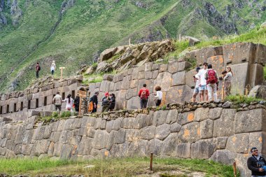 Cusco, Peru - March 17, 2025: Group of foreign tourists exploring Ollantaytambo Archaeological Site, a major Inca ruin and popular attraction in the Sacred Valley