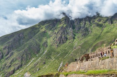 Ollantaytambo , Peru - March 17, 2025: Tourists exploring Ollantaytambo Archaeological Site, a major Inca ruin and popular attraction in the Sacred Valley