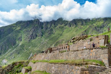 Ollantaytambo , Peru - March 17, 2025: Tourists exploring Ollantaytambo Archaeological Site, a major Inca ruin and popular attraction in the Sacred Valley