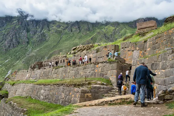 Cusco, Peru - March 17, 2025: Group of foreign tourists exploring Ollantaytambo Archaeological Site, a major Inca ruin and popular attraction in the Sacred Valley