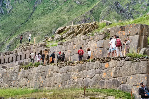 Cusco, Peru - March 17, 2025: Group of foreign tourists exploring Ollantaytambo Archaeological Site, a major Inca ruin and popular attraction in the Sacred Valley